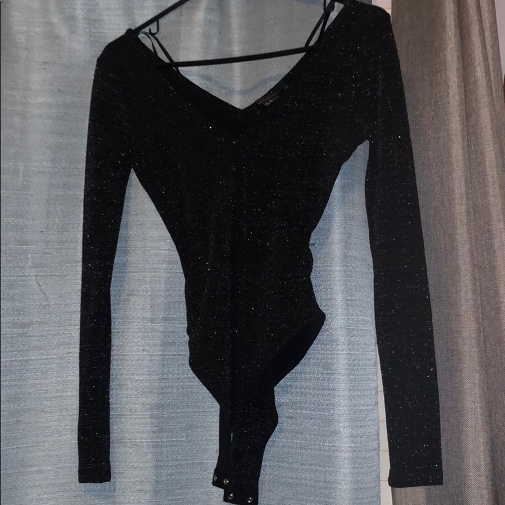 Brand new one piece long sleeve sparkly top.